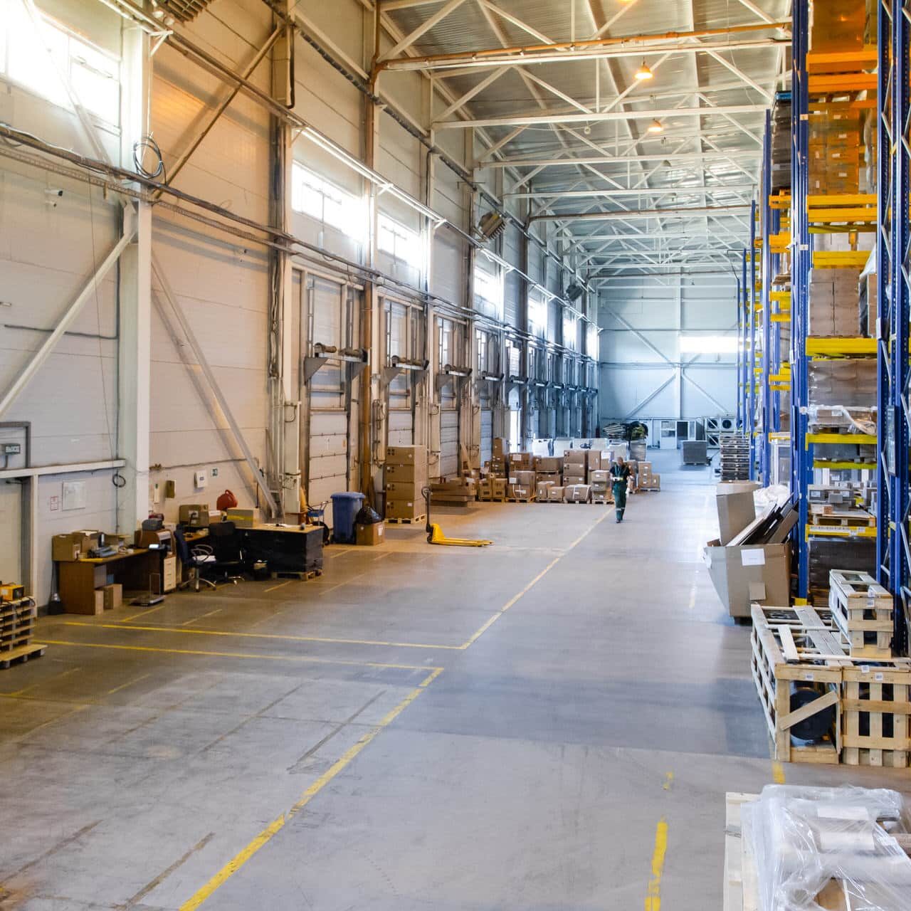 Interior of a modern warehouse storage with rows and goods boxes on high shelves